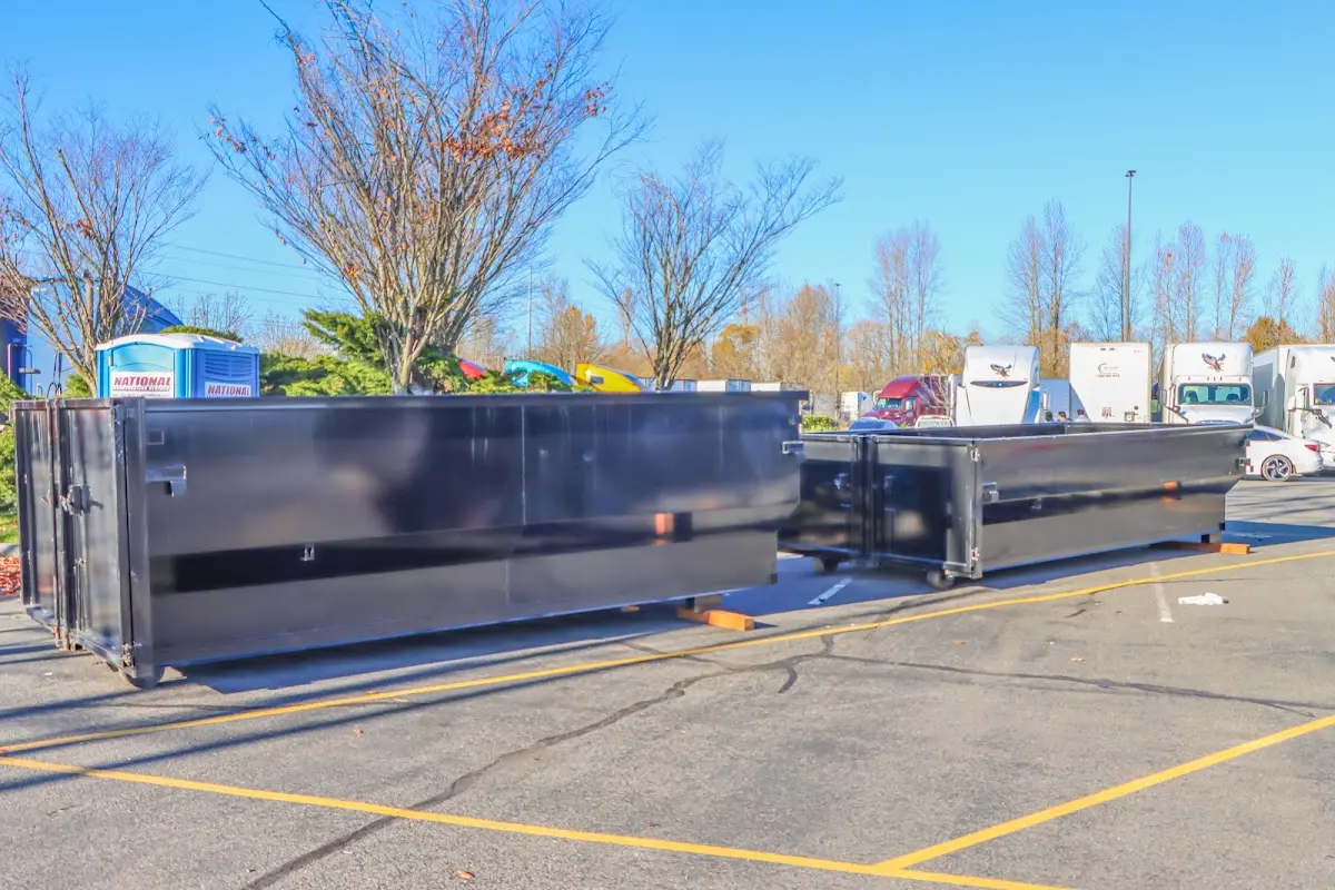 Professional dumpster rental service with roll-off container on residential driveway in Stewartville